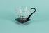 Large clear all glass cone shaped coffee dripper with ribs, sitting in a black plastic base and handle.